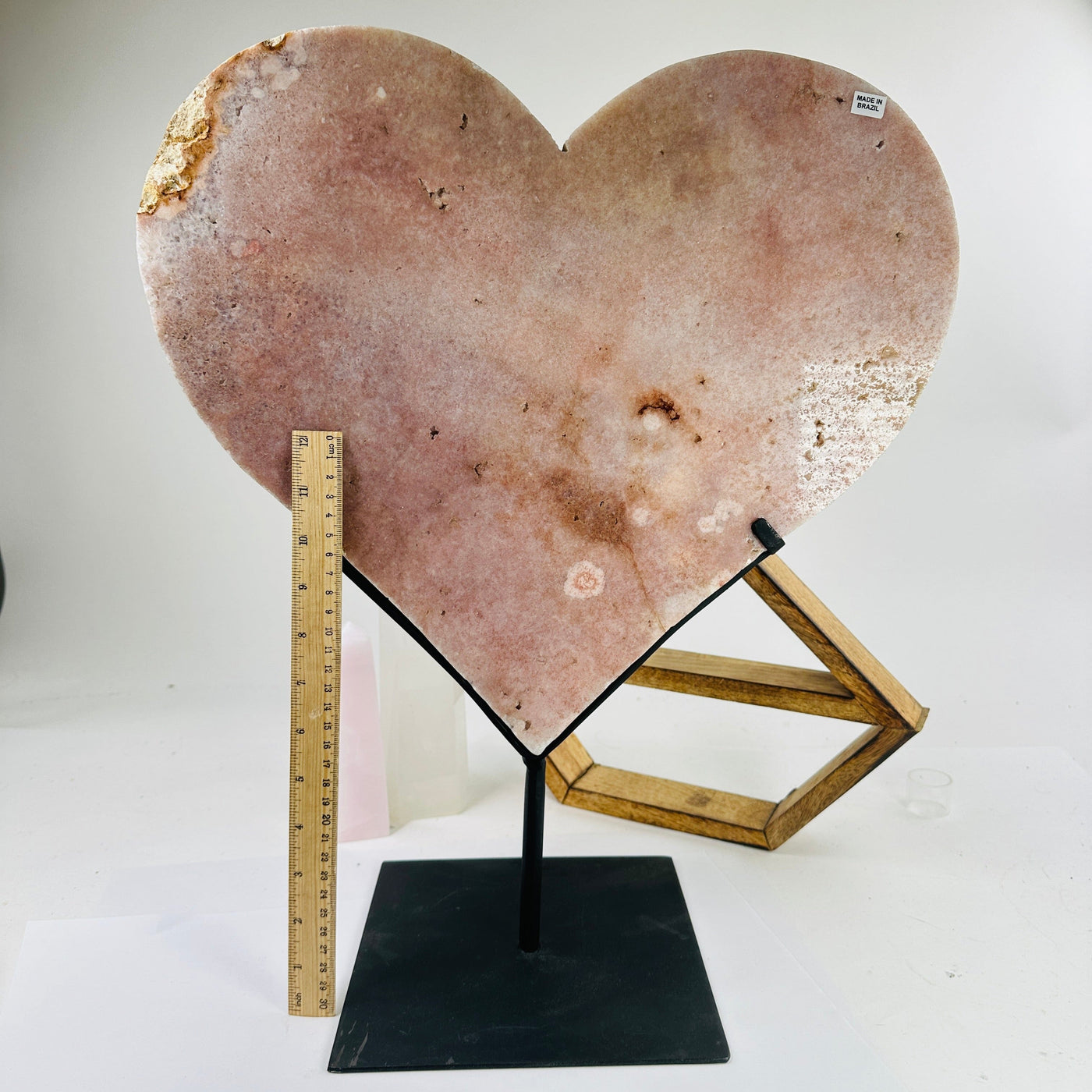 pink amethyst hearts next to a ruler for size reference