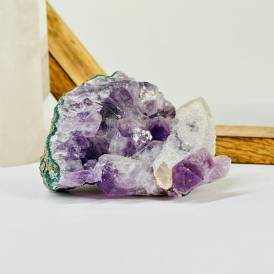 amethyst cluster with decorations in the background