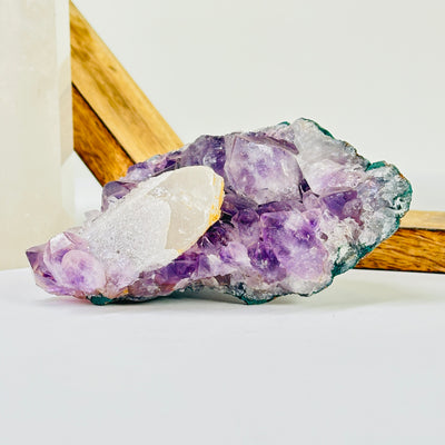 amethyst cluster with decorations in the background