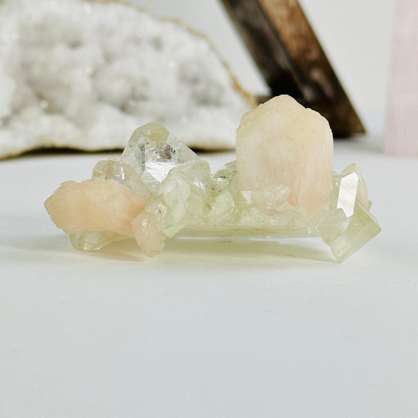  peach apophyllite with stilbite cluster with decorations in the background