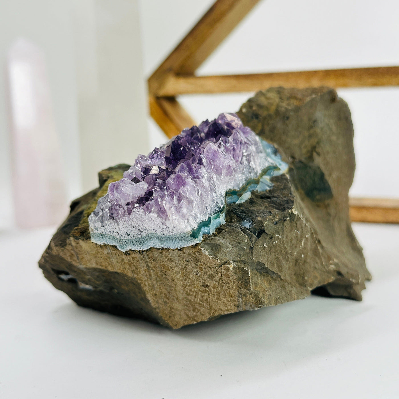 amethyst on matrix with decorations in the background