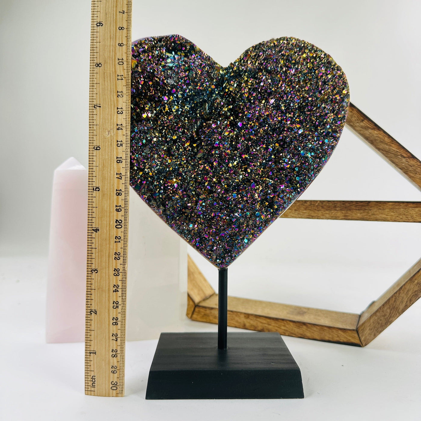 amethyst heart on stand next to a ruler for size reference