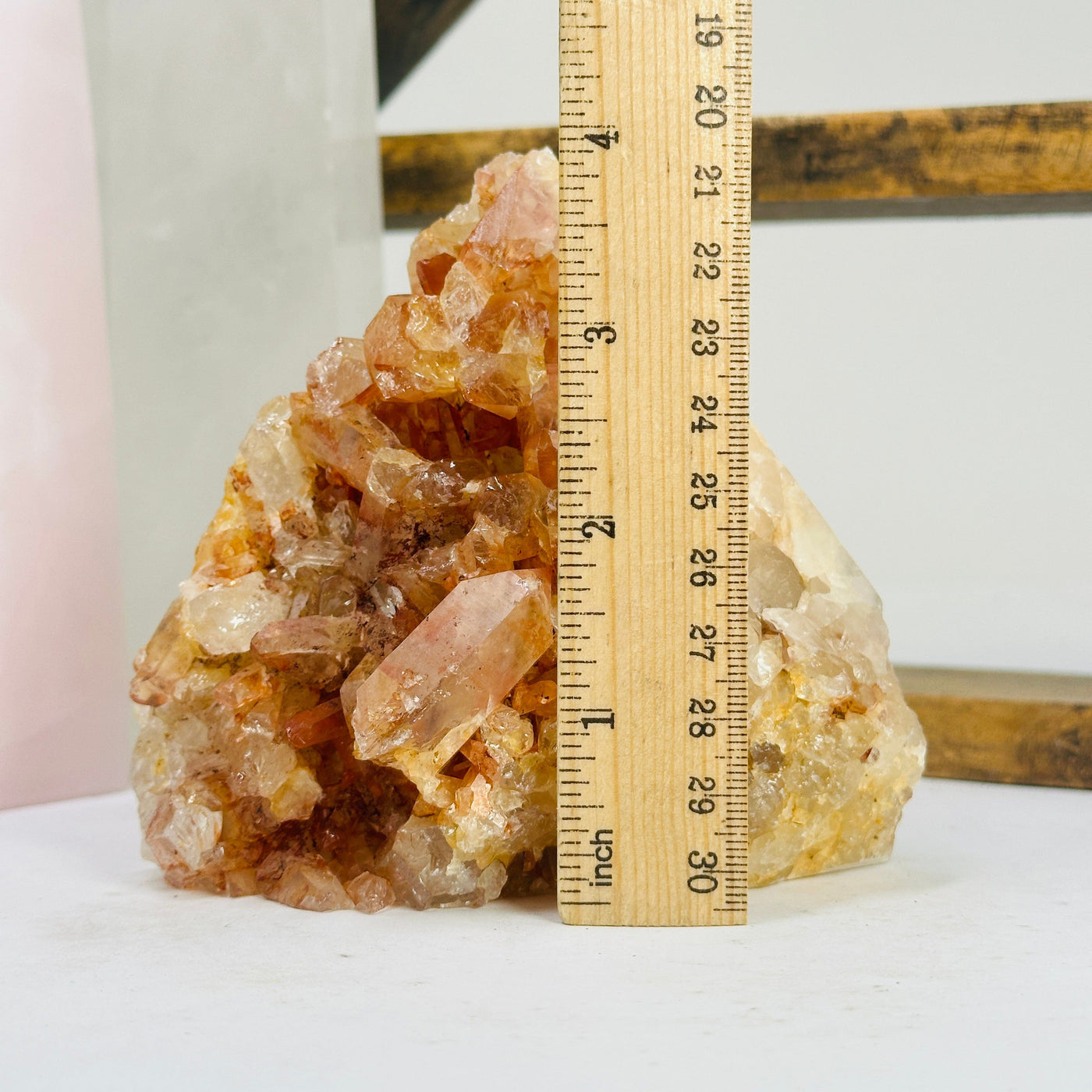 tangerine quartz points next to a ruler for size reference