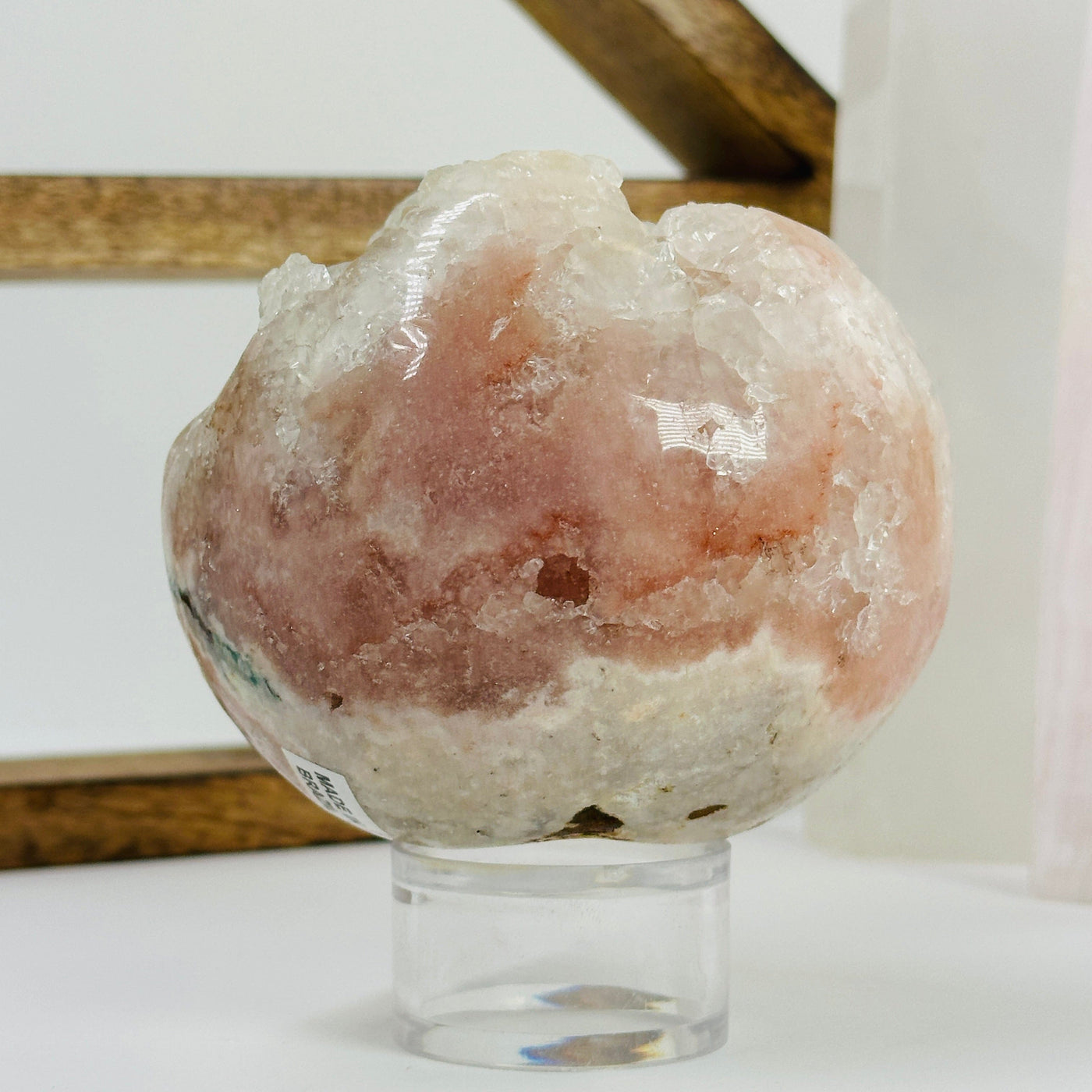 pink amethyst sphere with decorations in the background