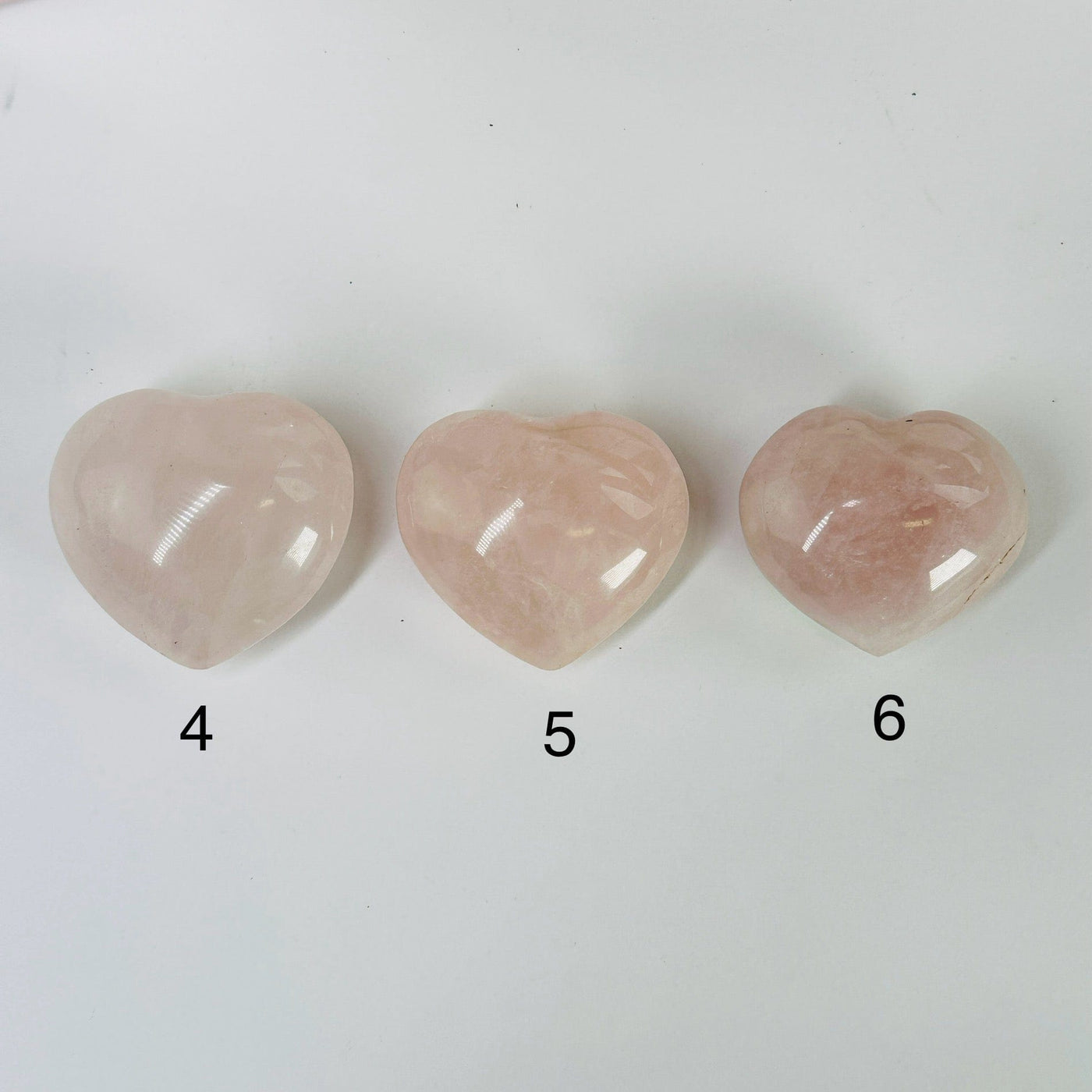 Rose Quartz Heart with decorations in the background