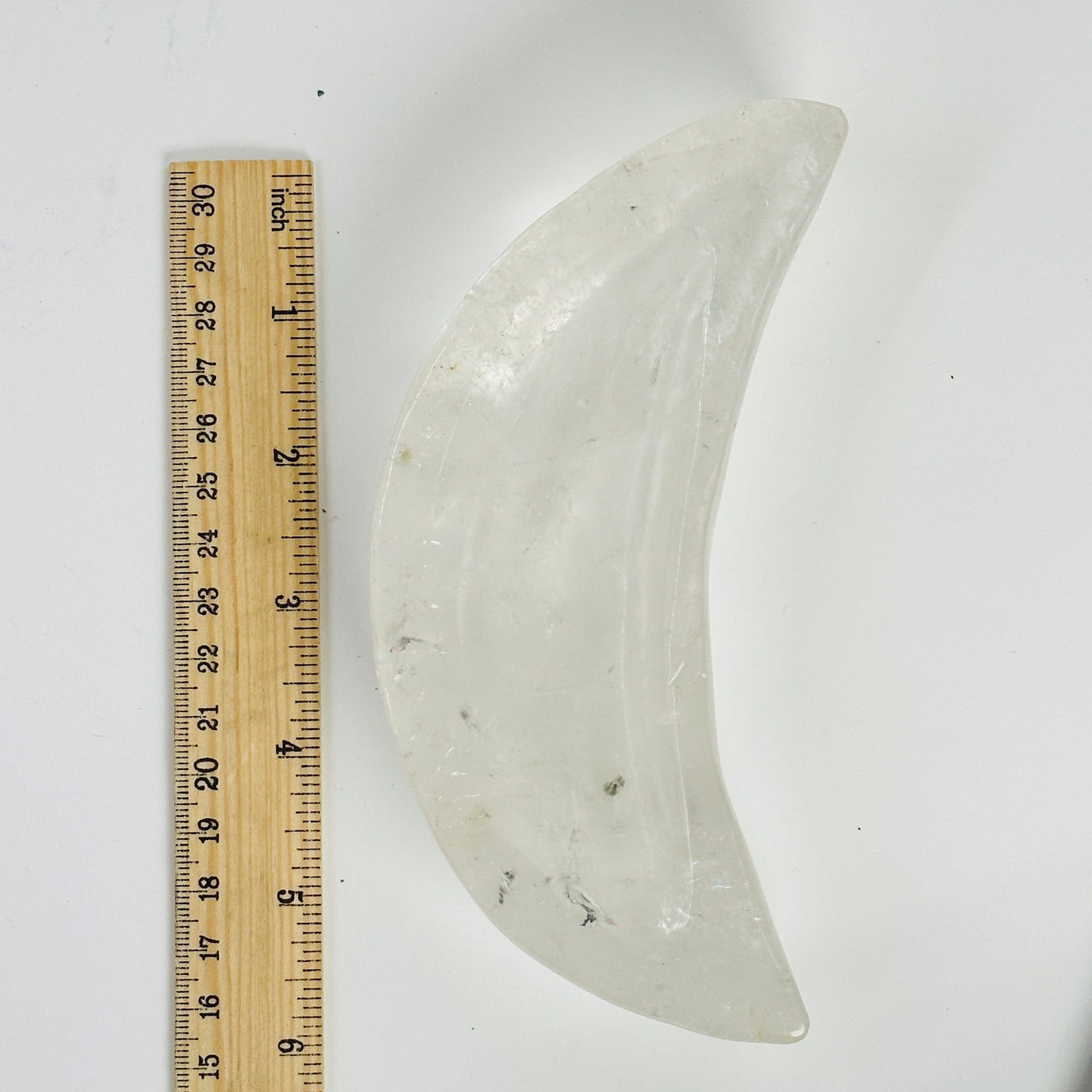 crystal quartz moon bowl next to a ruler for size reference