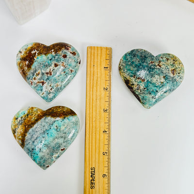 amazonite heart with decorations in the background