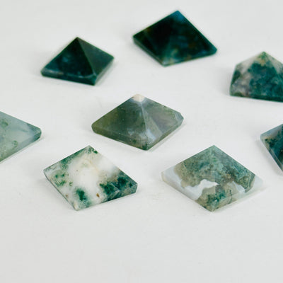 moss agate pyramids on white background