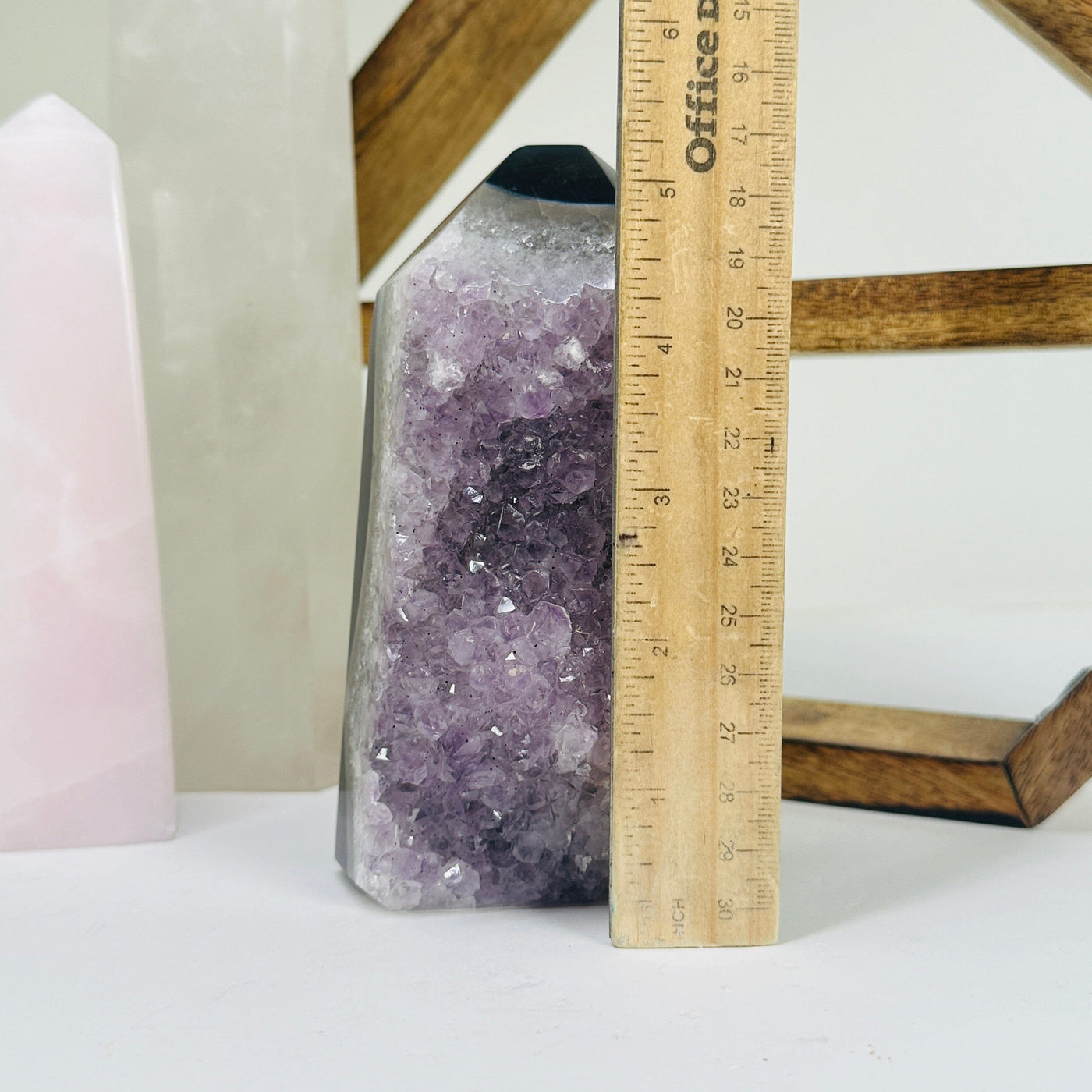 amethyst point next to a ruler for size reference