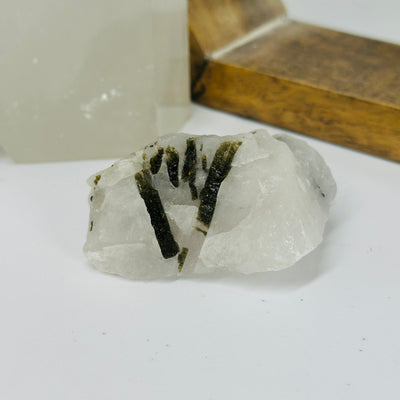 epidote on matrix with decorations in the background