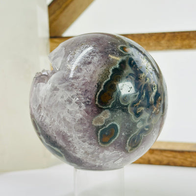 amethyst sphere with decorations in the background