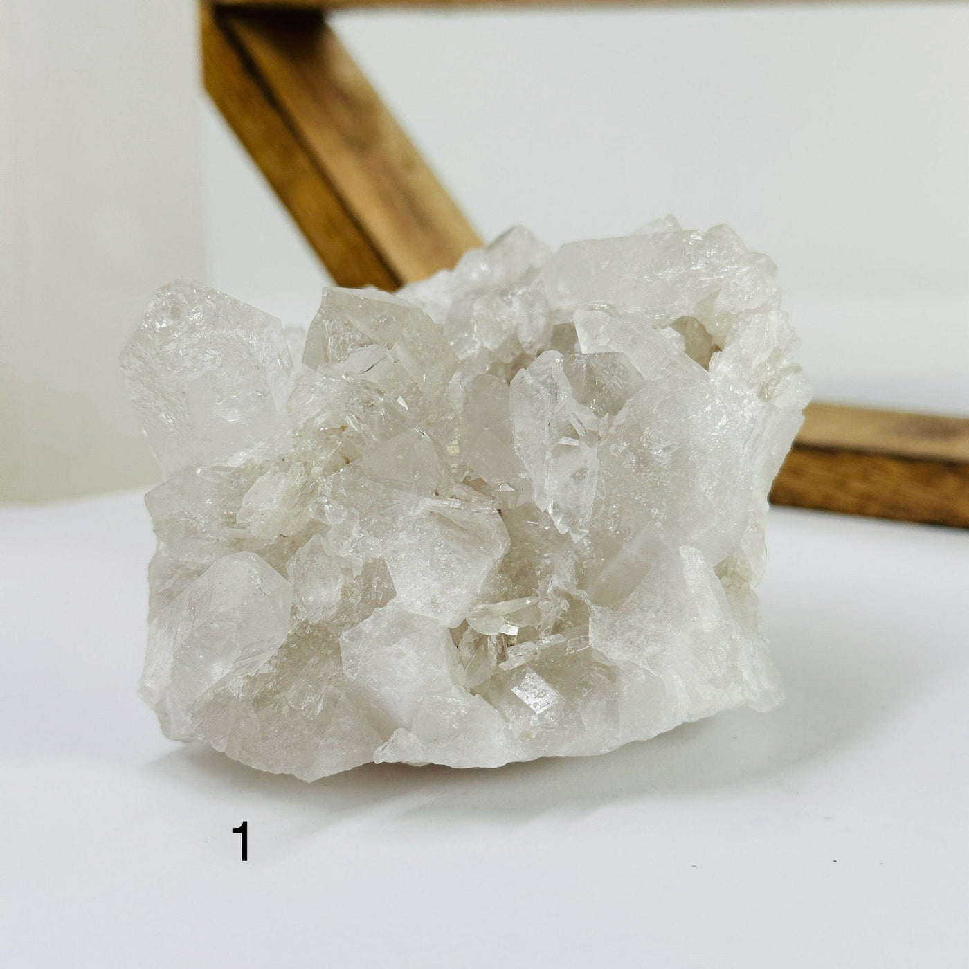 crystal quartz cluster with decorations in the background