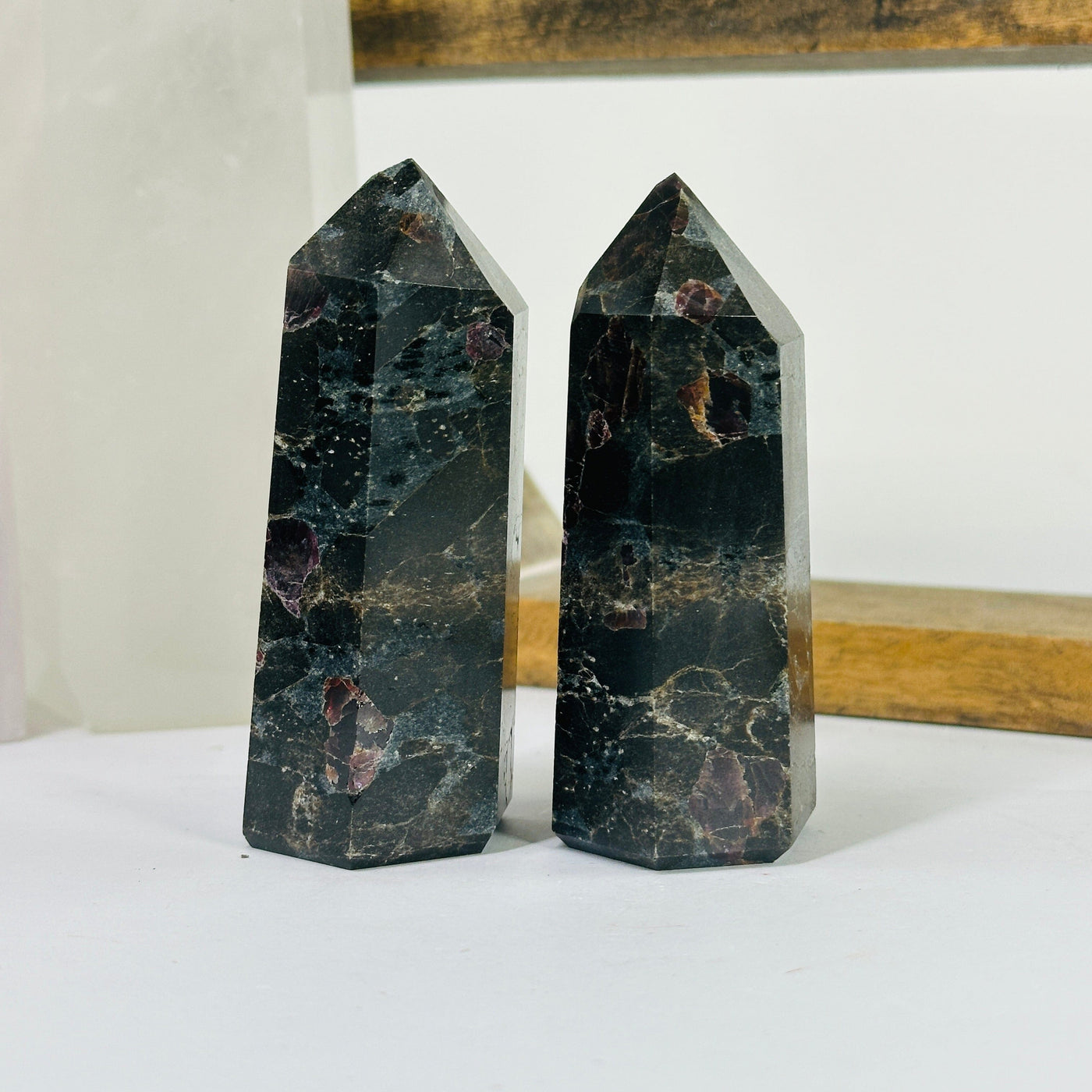 hematite point with decorations in the background