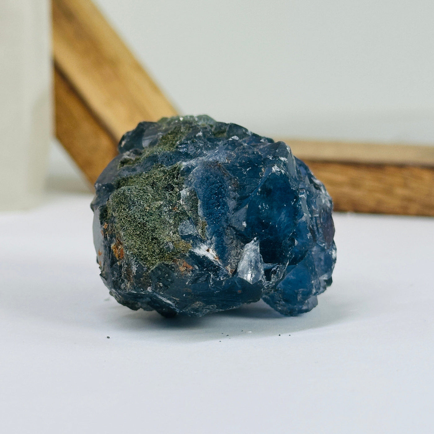 Blue fluorite crystal with decorations in the background