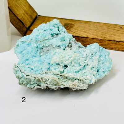 aragonite with decorations in the background