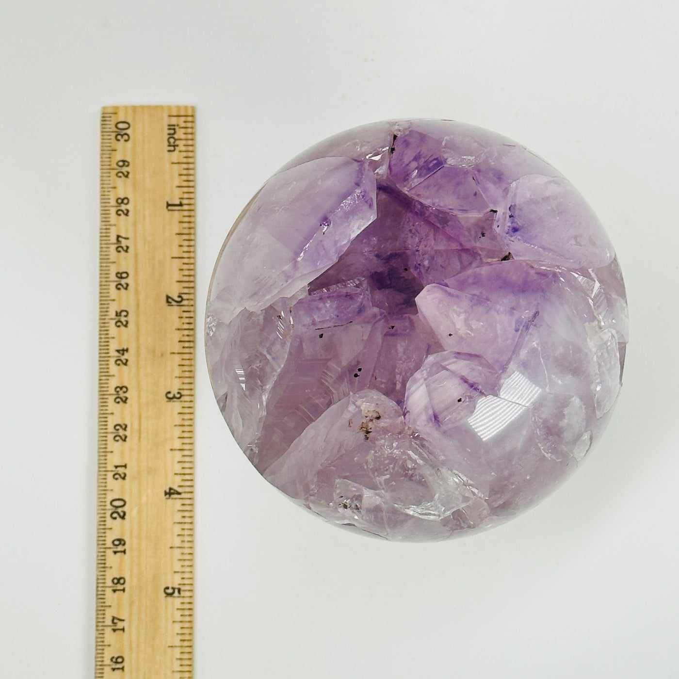 amethyst sphere next to a ruler for size reference