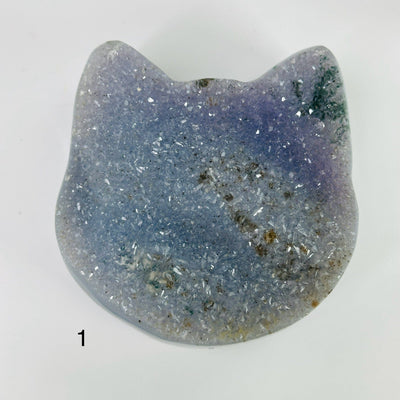 agate cat head with decorations in the background