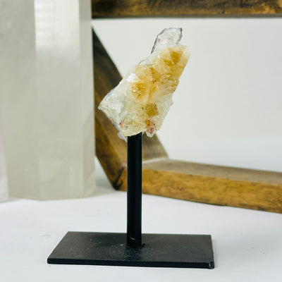citrine on metal stand with decorations in the background