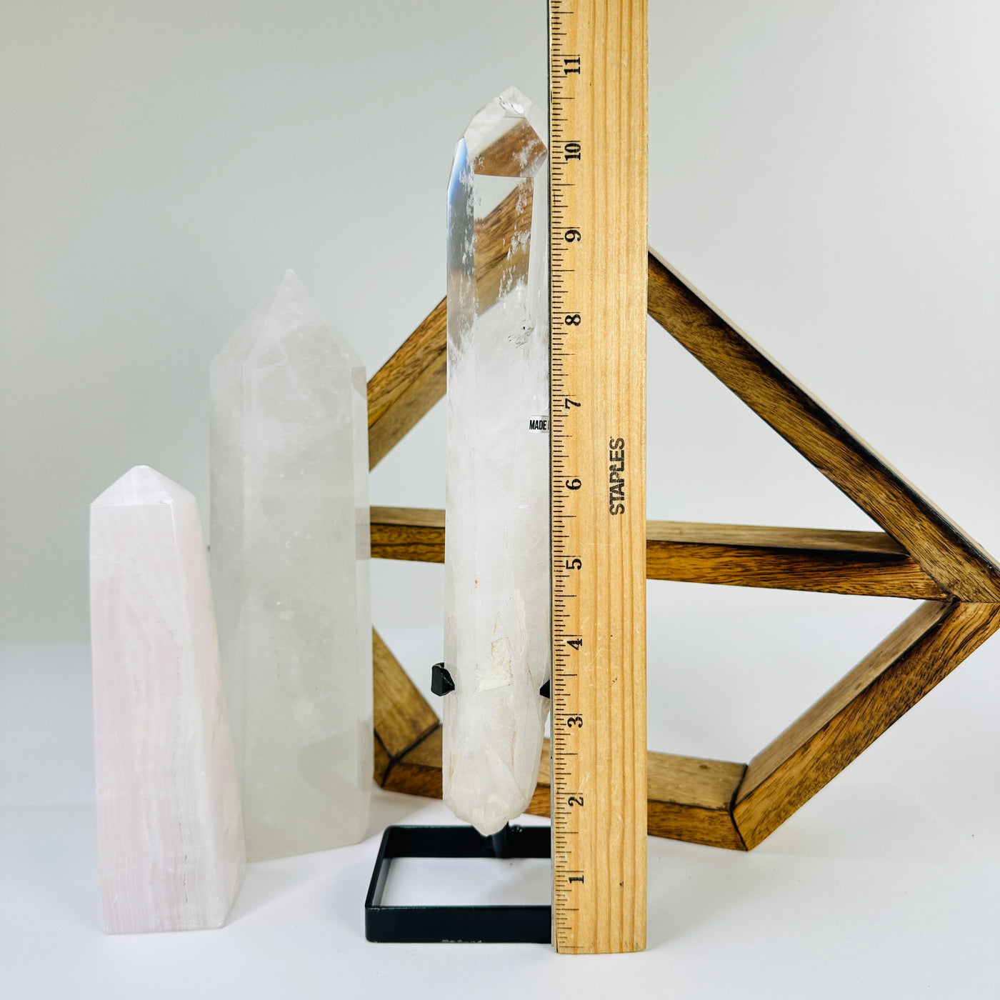 crystal quartz point next to a ruler for size reference