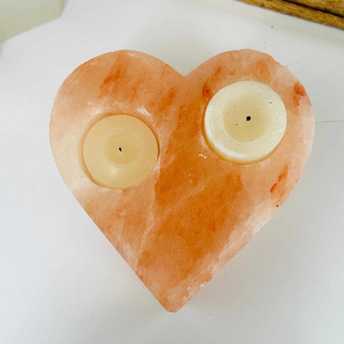 Himalayan salt candle holder with decorations in the background