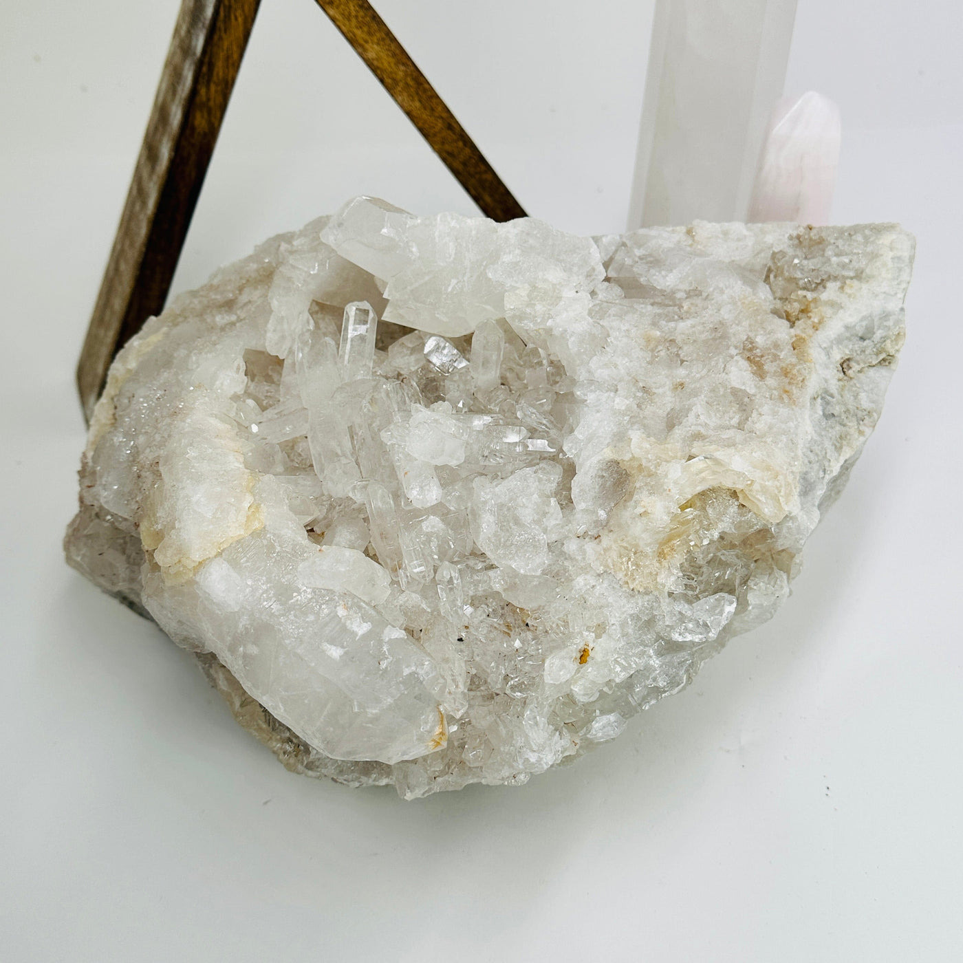 Crystal quartz cluster with decorations in the background