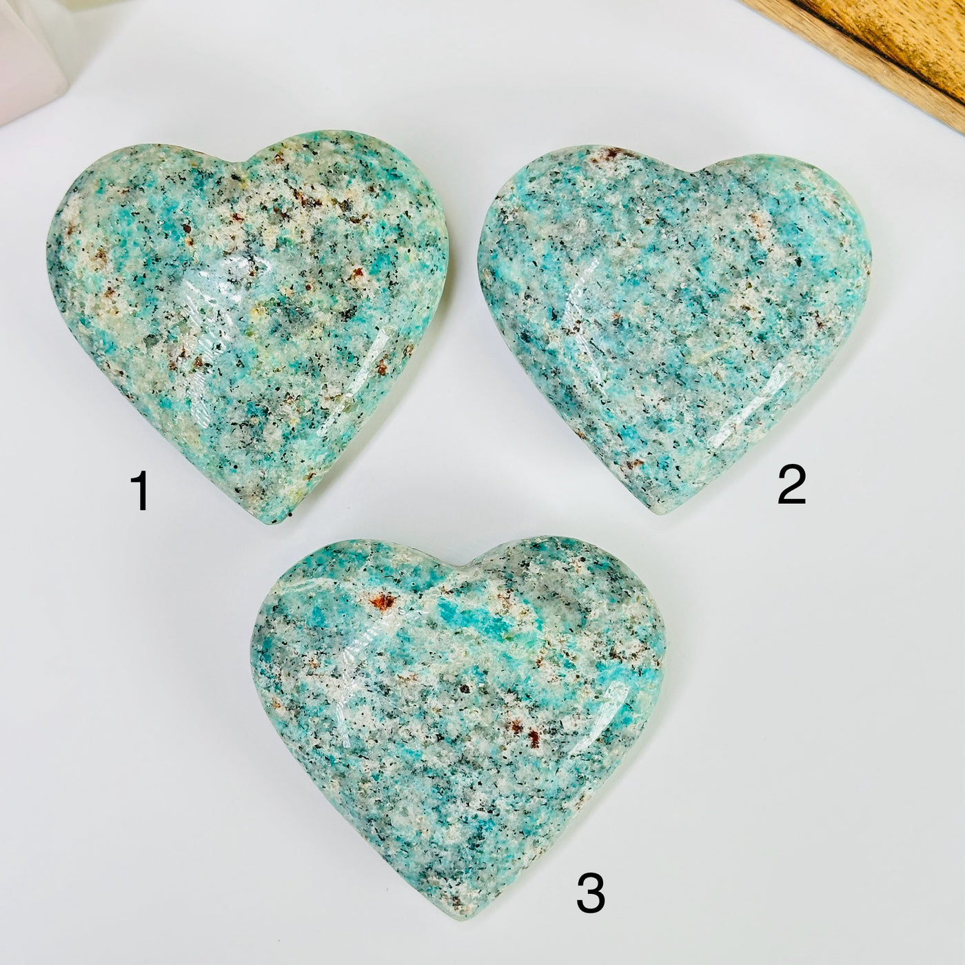 amazonite heart with decorations in the background