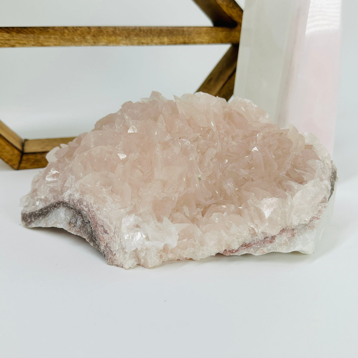 Pink chalcedony cluster with decorations in the background 