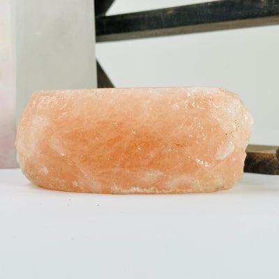 Himalayan salt candle holder with decorations in the background