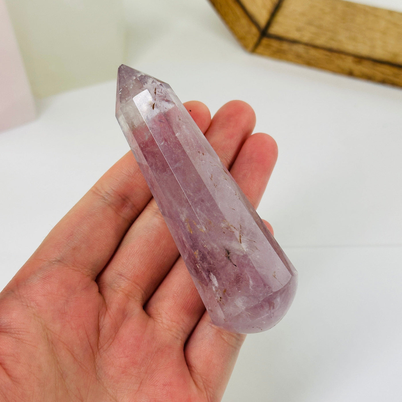 amethyst massage wand with decorations in the background