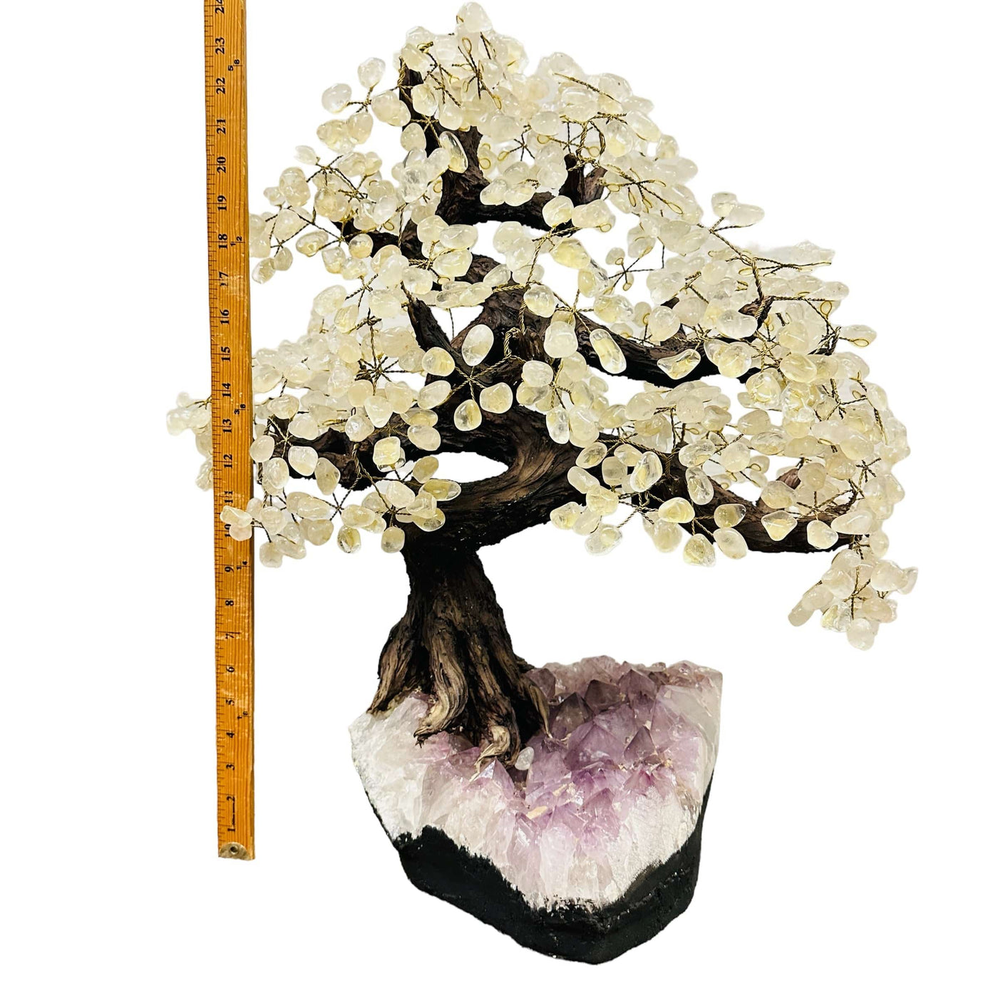 crystal quartz tree on amethyst stand next to a ruler for size reference