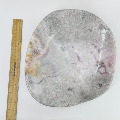 pink amethyst bowl next to a ruler for size reference