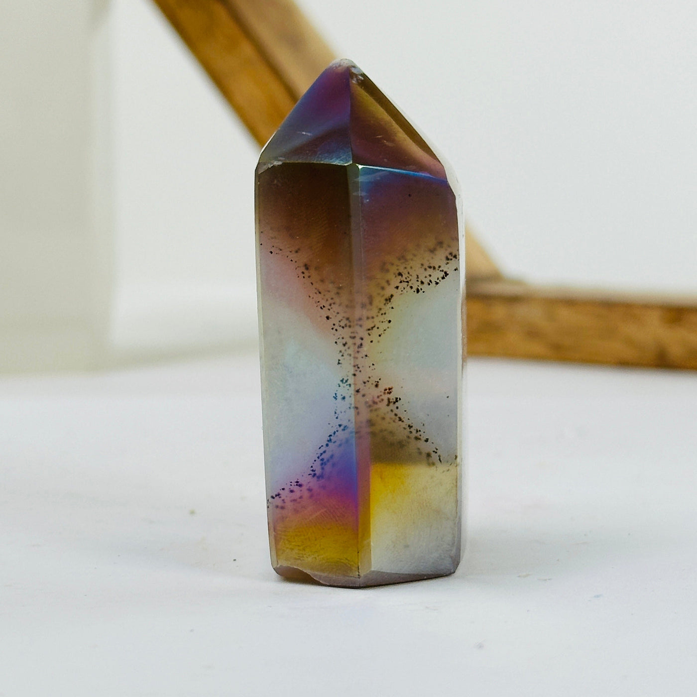 angel aura agate point with decorations in the background