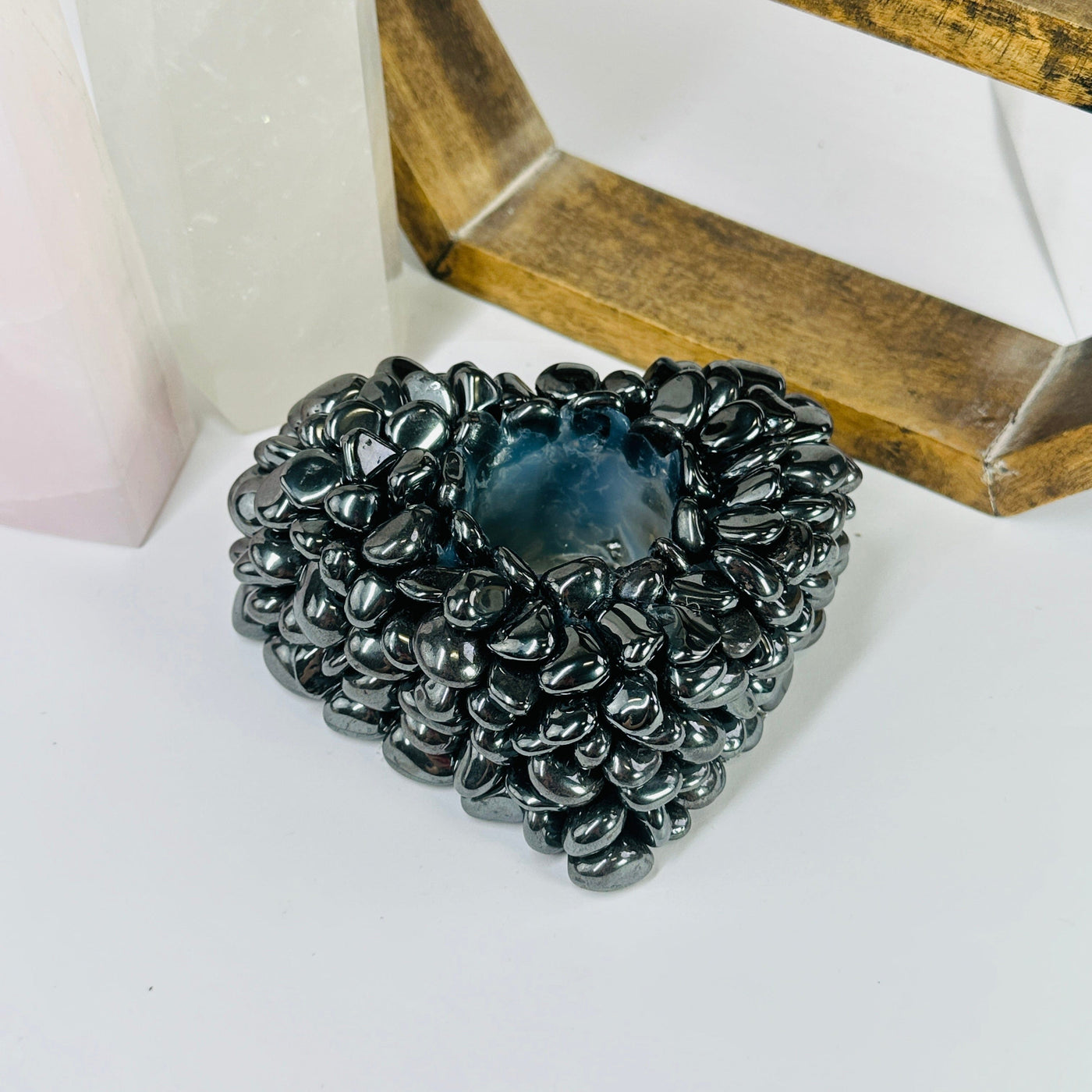 hematite candle holder with decorations in the background