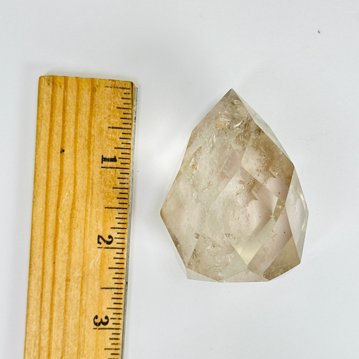 crystal quartz egg next to a ruler for size reference