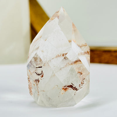 crystal quartz point with decorations in the background