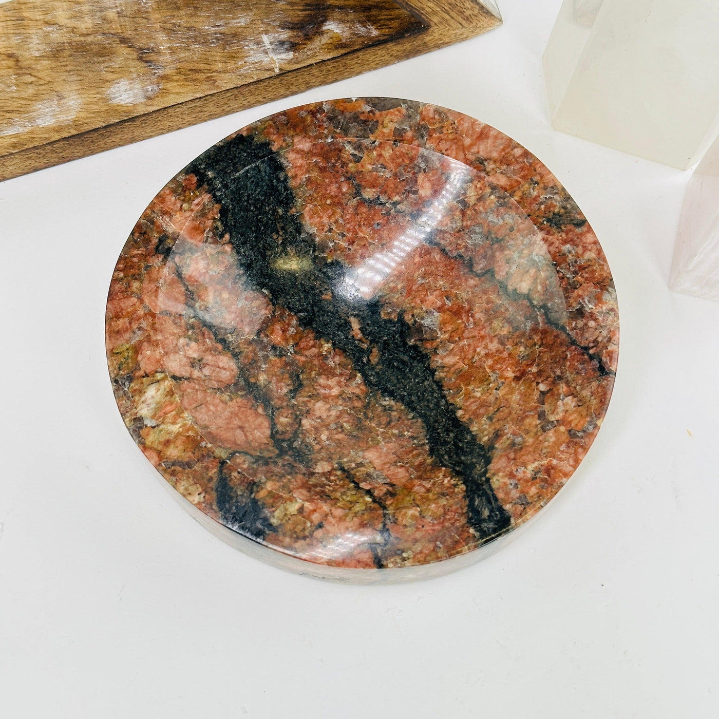 feldspar and tourmaline bowl with decorations in the background