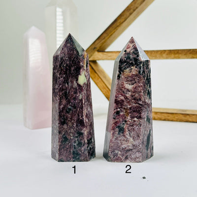 charoite points with decorations in the background