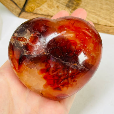 carnelian heart with decorations in the background