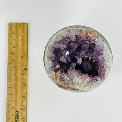 amethyst sphere next to a ruler for size reference