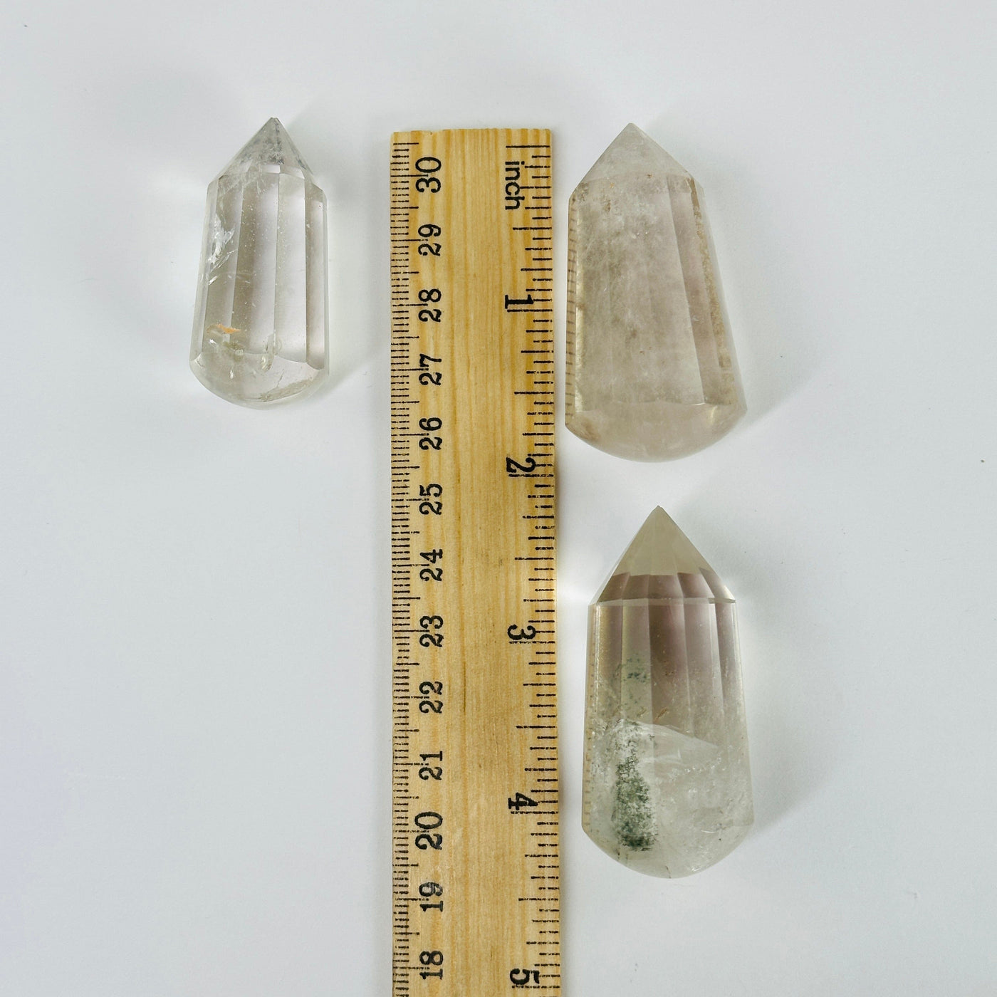 crystal quartz massage wands next to a ruler for size reference