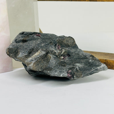 garnet on hematite matrix with decorations in the background