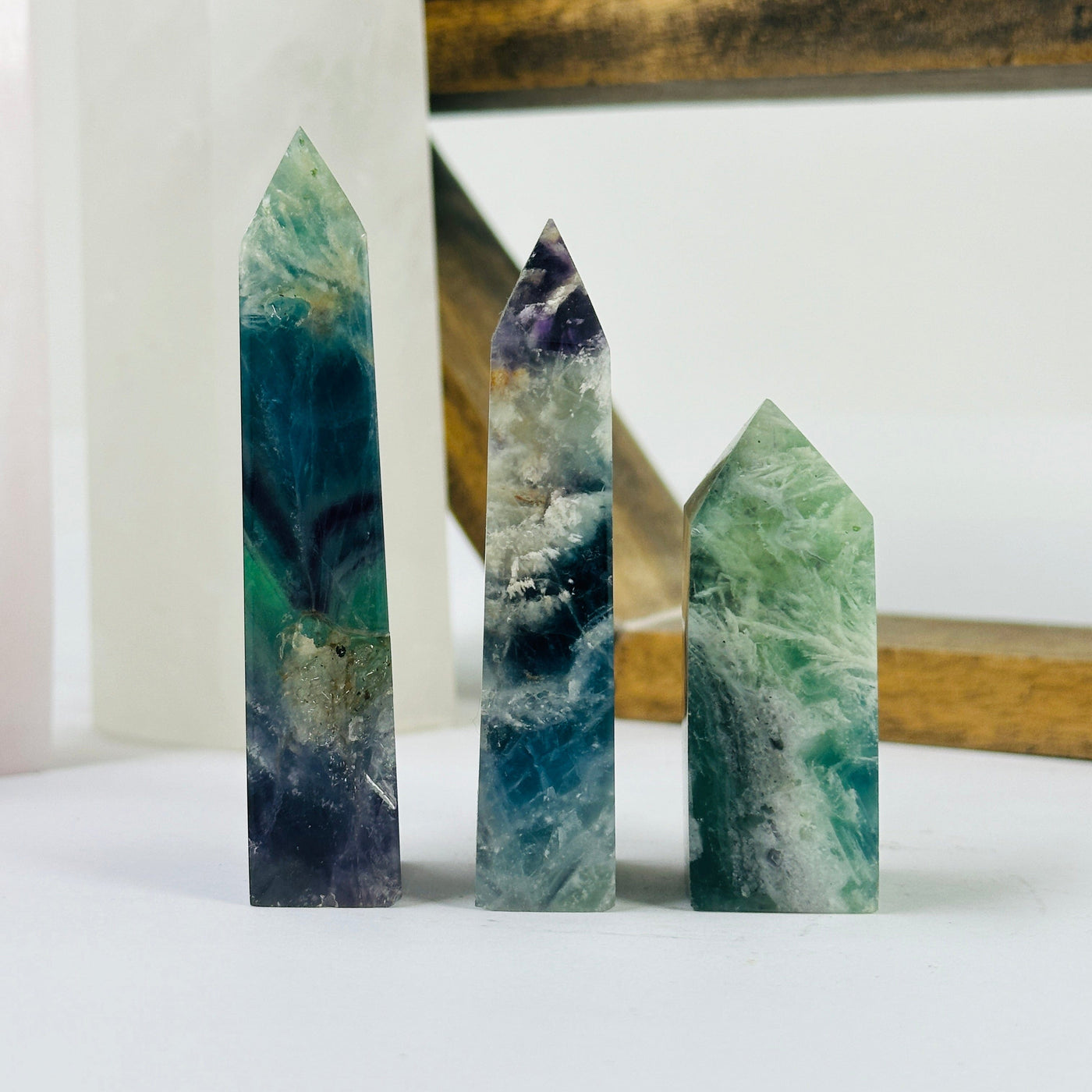 fluorite point with decorations in the background