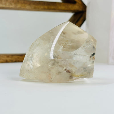 polished crystal quartz with decorations in the background