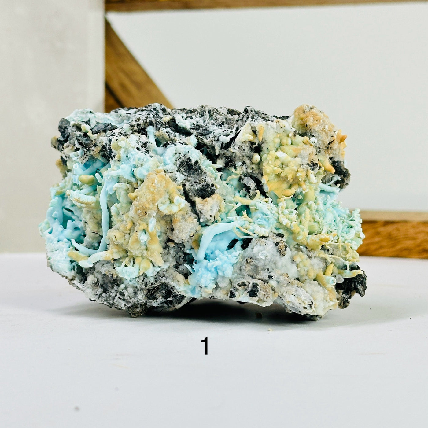 blue aragonite with decorations in the background