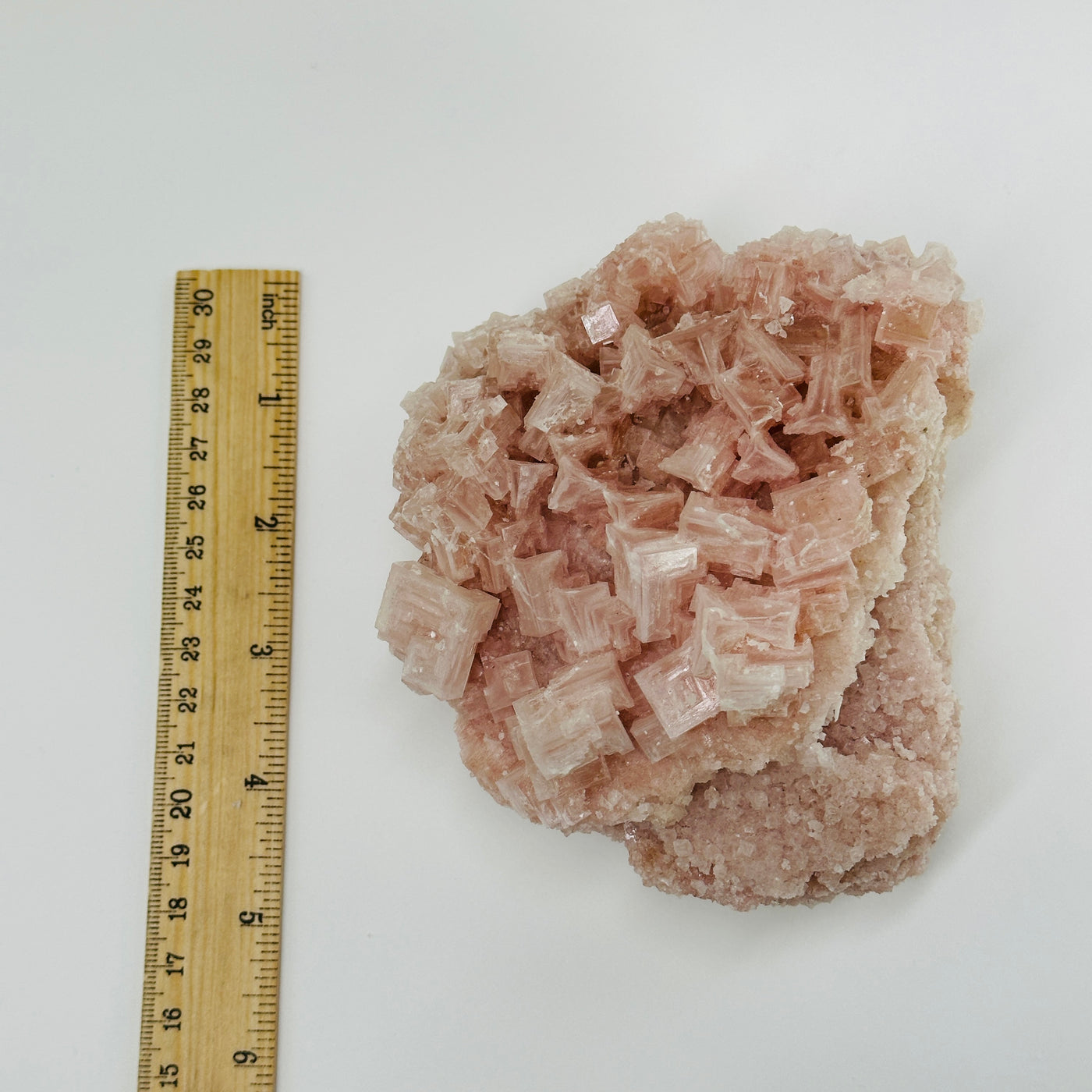 Pink halite next to a ruler for size reference