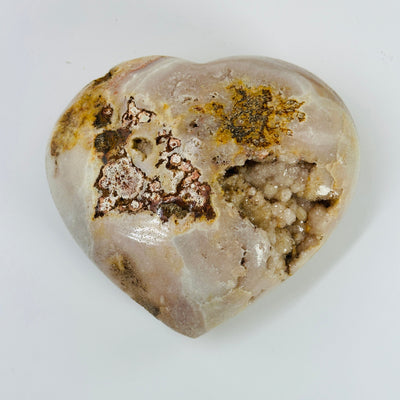 pink amethyst heart with decorations in the background