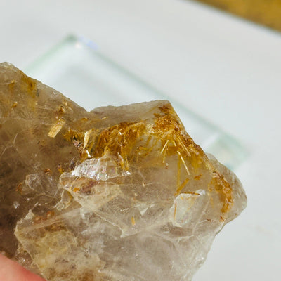 rutilated quartz with decorations in the background