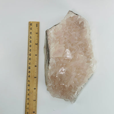 Pink chalcedony next to a ruler for size reference