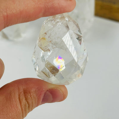 crystal quartz point with decorations in the background