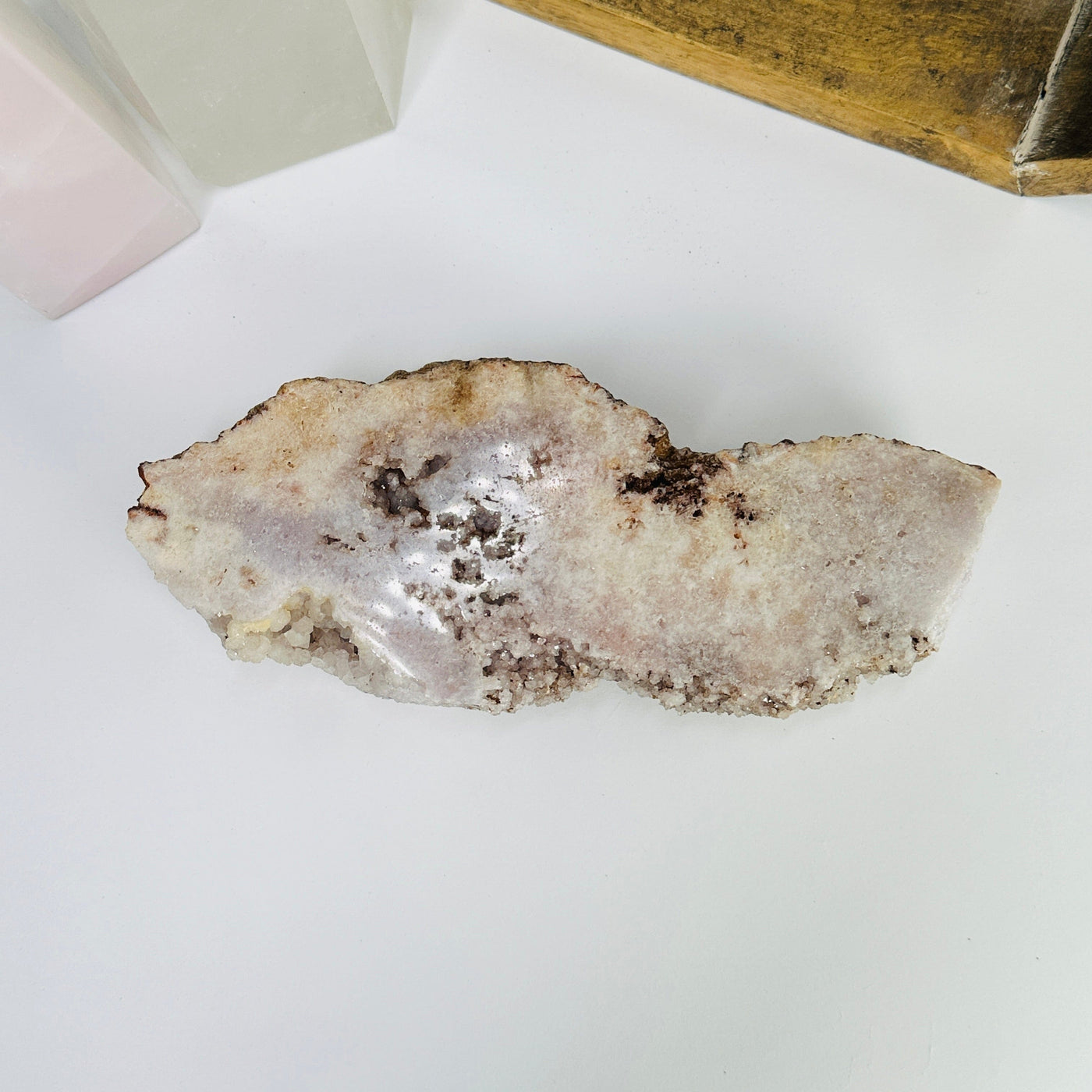 pink amethyst slab with decorations in the background